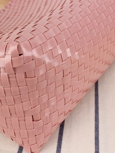 Pink macaron plastic woven handbag with intricate cross-weave texture for picnic