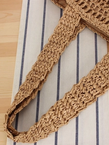 Minimalist hand-woven straw shoulder bag for beach vacations with high-quality texture