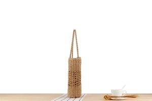 Detail of hand-woven paper rope shoulder bag with hollow diamond mesh pattern