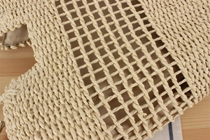 Detail of hollow paper rope woven beach bag with inner lining on wood background