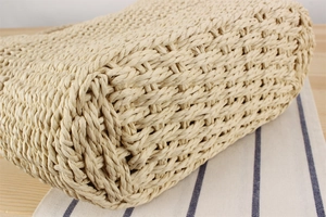 Close-up of woven paper rope texture and reinforced corner on a French beach bag