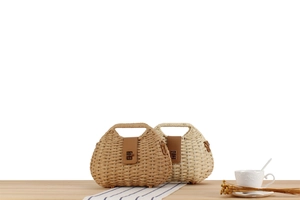 Close-up of woven paper rope handbags with leather metal clasps on a wooden surface