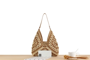 Macro detail of hand-woven crochet shoulder bag with hollow geometric pattern