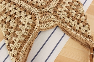Detail shot of the two-tone woven texture and inner fabric lining of the straw tote bag