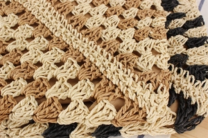 Close-up of woven paper rope bag detail with wave pattern and brown fabric lining