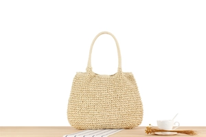 Detail of hand-woven paper rope shoulder bag with textured finish for beach vacations