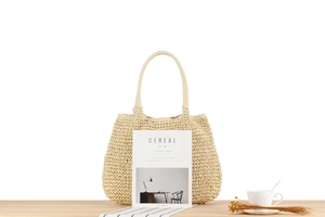 Handwoven beige paper rope tote bag displayed with a minimalist aesthetic for summer travel