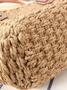 Large woven tote bag with brown leather straps and thick straw rope texture for summer travel