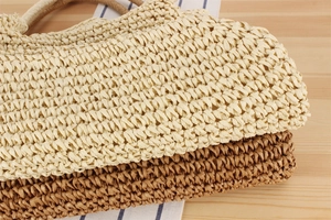 Close-up of woven paper rope shoulder bag showing dense texture and sturdy handles