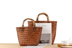 Detailed close-up of retro woven handbags with bamboo handles in two different sizes