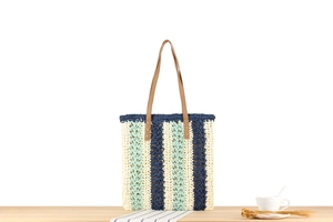 Detailed view of woven tote bag with tricolor stripes and hollow crochet texture
