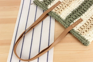 Macro detail of paper rope tote with brown leather handles and contrast cross-stitching