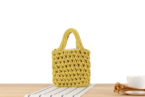 Close-up of mustard yellow hollow woven bag with cotton rope texture and inner lining