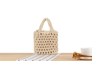 Detailed close-up of handmade beige woven tote bag with sturdy handles and cotton lining