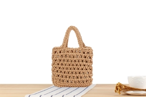 Detailed texture of handmade hollow woven bag with light brown cotton rope and soft lining