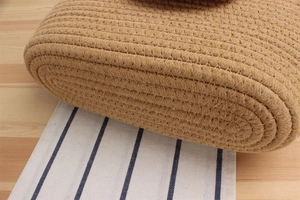 Close-up of woven straw texture with white stitching on a large beach tote bag