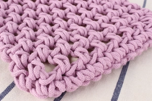 Detailed close-up of intricate lilac hand-woven rope texture and honeycomb knit pattern
