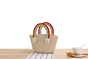 Detail of handmade cotton rope woven rainbow bag with colorful handles and fringe