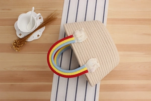 Close-up of handmade rainbow cotton rope woven handbag with colorful handle and tassel