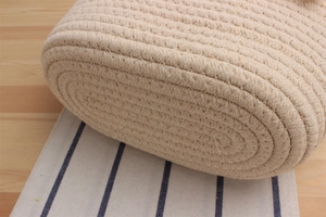 Close-up of hand-woven cotton rope texture and detailed stitching on the beige beach bag