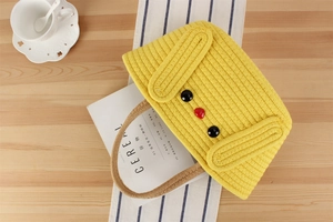Detail of yellow handmade crochet bag featuring a cute cartoon dog face with long ears