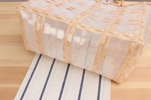 Detail shot of the woven plastic lattice pattern on a handcrafted beach basket bag