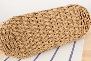 Detailed close-up of woven paper rope texture and artisanal pattern on a beach tote bag