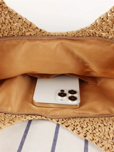 Handwoven straw tote bag with satin lining, interior pocket and secure zipper closure