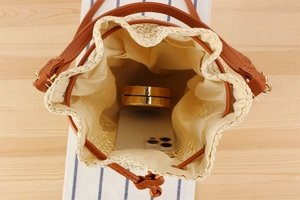 Top view of woven straw bucket bag showing interior storage capacity and drawstring closure
