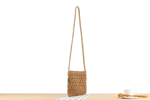 Close-up of geometric hollow-out pattern and fine texture on vintage woven paper rope bag