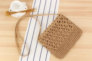 Macro detail of hand-woven straw shoulder bag with star-shaped hollow pattern craftsmanship