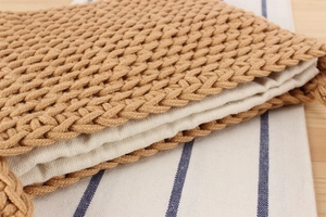 Detailed close-up of brown cotton rope weave texture and soft cream linen lining