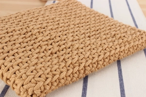 Detailed close-up of textured cotton rope weave on a beige casual shoulder bag