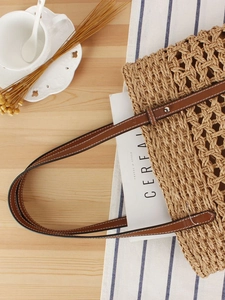 French style woven paper rope beach tote with premium brown leather straps on wood table