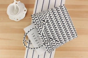 Top view of woven tote bag with black and white herringbone pattern and spacious interior