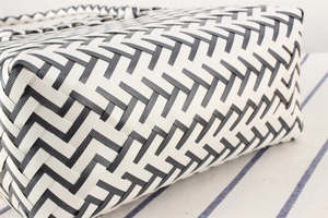 Close-up of black and white striped woven plastic basket showing durable texture and pattern