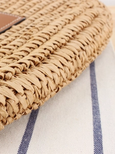 Large capacity woven tote bag in khaki straw with brown leather trim for summer commute