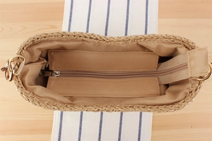 Detail view of woven paper rope bag featuring top zipper closure and interior lining