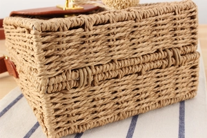 Detail shot of vintage woven straw crossbody bag with brown leather flap and metal lock