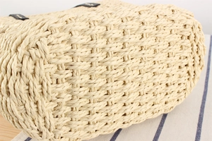 Close-up of tight cross-weave texture on natural straw beach bag base