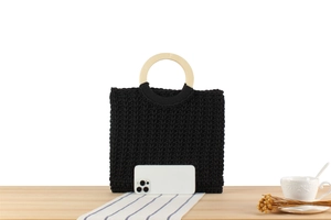 Detail of black woven cotton tote with wood handle and smartphone for size reference