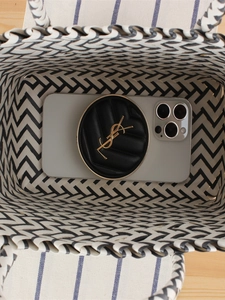 Vertical top view of black and white striped woven tote bag showing internal storage capacity