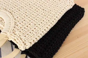 Close-up of thick cotton rope weave and smooth wooden handles on beige and black tote bags