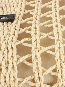 Retro hollow woven tote bag with beige fiber mesh and black leather trim for beach vacations