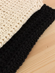 Handwoven cotton rope tote bag with wooden handles in cream and black braided patterns