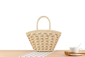 Close-up of woven straw tote bag with wave patterns and sturdy handles on wooden table