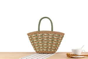 Detail of geometric pattern woven straw handbag on wooden table with summer decor