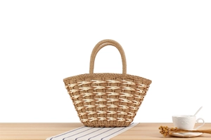 Detailed view of handmade woven pattern and sturdy handles of this summer beach tote bag