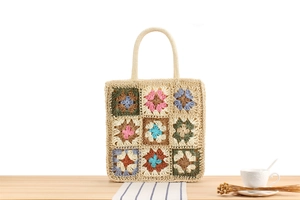 Detail of bohemian handmade crochet tote bag featuring colorful floral pattern patchwork