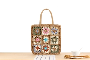 Detail of handmade crochet bohemian tote bag with colorful granny square patterns